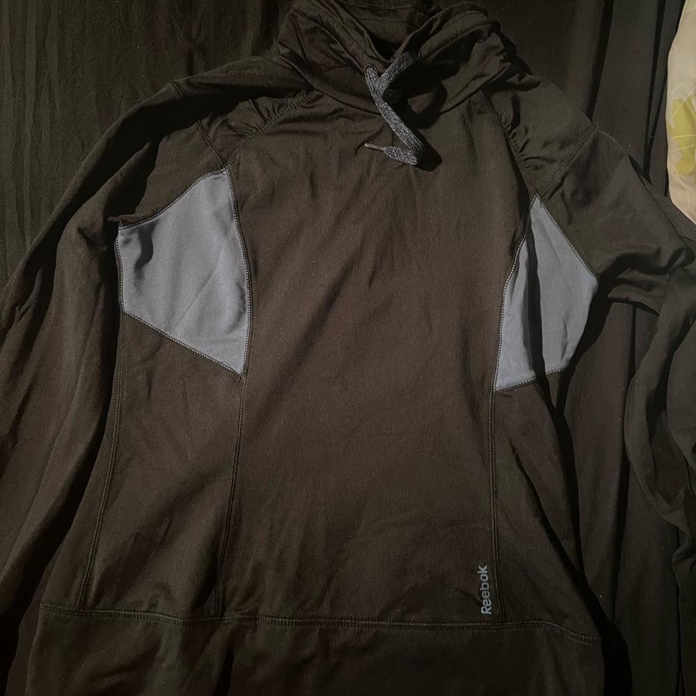 Reebok black high colar sweat shirt with grayish/blue trim.